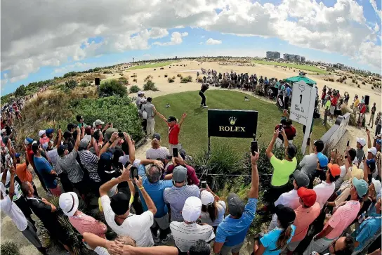  ?? PHOTO: GETTY IMAGES ?? The large crowd gathered around the first tee tells its own story as Tiger Woods begins his latest comeback at the Hero World Challenge in the Bahamas.