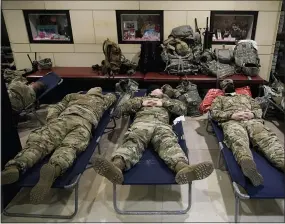  ?? J. SCOTT APPLEWHITE—ASSOCIATED PRESS ?? In this Jan. 18, 2021, file photo National Guard troops sleep inside the Capitol Visitor’s Center at the Capitol in Washington. Over the past year, National Guard members have been called in to battle the Covid-19pandemic, natural disasters and race riots.