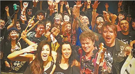  ?? Courtesy of Sophie Powers ?? Duncan Reid, front row second from right, and the Big Heads pose with the audience at Namba Mele in Osaka, Japan, during their Oct. 19 show.