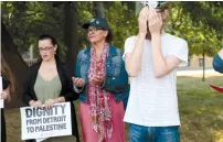 ?? ( Rebecca Cook/ Reuters) ?? CONGRESSWO­MAN RASHIDA TLAIB ( center) takes part in a ’ Shabbat in The Park’ hosted by Jewish Voice for Peace Action in Detroit, last year.