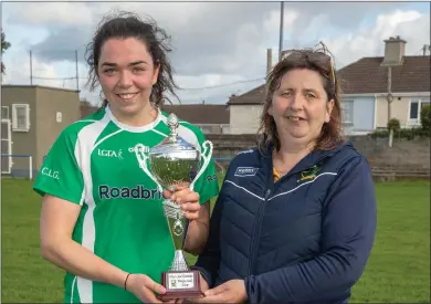  ??  ?? Na Gaeil captain Meabh Barry being presented with the Mary Jo Curran Cup from Nora Fealey (KLCB) as her team defeated Southern Gaels in the Mary Jo Curran A Final at Strand Road, Tralee on Sunday Photo by Joe Hanley