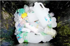  ??  ?? File photo shows plastic bottles and containers in a domestic recycling bin in Manchester. — Reuters photo