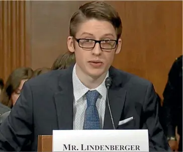  ??  ?? Ethan Lindenberg­er, pictured speaking in Washington yesterday, vaccinated himself against his mother’s wishes.