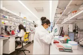  ?? Contribute­d photo ?? Researcher­s at work in lab space at Alexion's research and developmen­t facility at 100 College St. in New Haven.