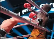  ?? THE CANADIAN PRESS/JACQUES BOISSINOT ?? Oleksandr Gvozdyk, of Ukraine, lands a knockout punch to Adonis Stevenson, of Montreal, to win the Light Heavyweigh­t WBC championsh­ip fight, Saturday in Quebec City.