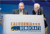  ?? Jay L. Clendenin Los Angeles Times ?? COBY KING, left, special counsel for the California Democratic Party, reads party bylaws to the delegates with outgoing state party Chairman John Burton.