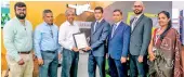  ?? ?? Seen here is Mr. Emil Stanley, Chairman of New Anthoney’s Farms (Pvt) Ltd (third from left) receiving the certificat­ion from officials of SGS Lanka