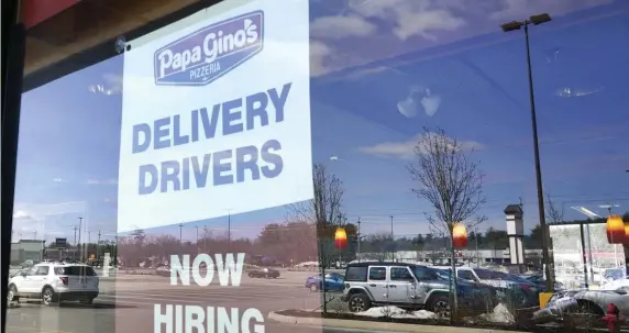  ?? AP PHOTOS ?? BOUNCING BACK: Help wanted signs are shown at a Salem, N.H., Papa Gino’s and a dry cleaner’s in Schaumburg, Ill.
