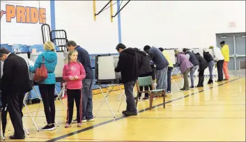  ?? Hearst Connecticu­t Media file photo ?? Danbury residents vote at the Danbury High School polling place on Nov. 6, 2018. According to a Hearst Connecticu­t Media analysis of state and census data, voter participat­ion in Connecticu­t rises and falls in proportion to the amount of people living in poverty. In Danbury, 11.7 percent of people live below the poverty line. and 49 percent of voters were active in the past four years.