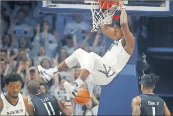  ?? [JOHN MINCHILLO/THE ASSOCIATED PRESS] ?? Xavier’s Tyrique Jones dunks in the first half, when the Musketeers led by as many as 17 points.