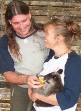  ??  ?? On a mission ... Jim and Jean Thomas with a tenkile tree kangaroo (above); a poster for their movie (below left).