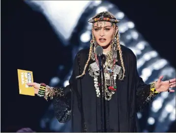  ?? MICHAEL LOCCISANO / GETTY IMAGES FOR MTV ?? Madonna speaks onstage during the 2018 MTV Video Music Awards on Monday at Radio City Music Hall in New York City.