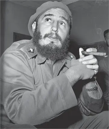  ?? Associated Press ?? AN ICONIC FIGURE The death of Fidel Castro, shown in 1961 with his familiar cigar, was far from unexpected after his recent years of declining health, but a profound sense of loss was evident among many Cubans.