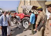  ?? — PTI ?? Farmers repair a tractor after ending the Kisan Kranti Padyatra at NH24 on Delhi- UP border on Wednesday.