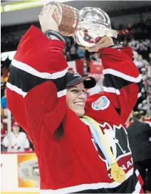  ?? ANDREW VAUGHAN
THE CANADIAN PRESS FILE PHOTO ?? Kim St-Pierre hoists the trophy to celebrate Canada’s gold-medal victory at the world championsh­ip in 2004. St-Pierre was inducted into the Hockey Hall of Fame on Wednesday.