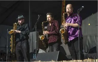  ?? THE ASSOCIATED PRESS ?? From left, Stephen “Doc” Kupka, Richard Elliot and Emilio Castillo, part of Tower of Power’s horn section, perform with the band at the 2017New Orleans Jazz and Heritage Festival.