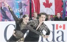  ?? PAUL CHIASSON/THE CANADIAN PRESS ?? Tessa Virtue and Scott Moir are first after the short dance Friday at Skate Canada Internatio­nal in Regina.