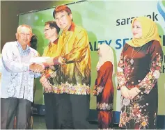  ??  ?? Sharbini presenting a loyalty service award to Abdul Nasir (left) who is sole recipient for the 40 years of service category.