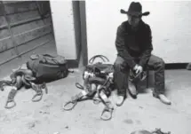  ??  ?? Cowboy and saddle bronc rider Johnny Espeland, of Redmond, Ore., gets prepared for his event Sunday behind the Denver Coliseum at the National Western Stock Show.