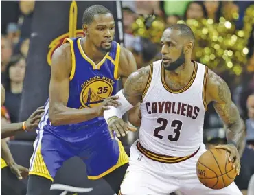  ?? THE ASSOCIATED PRESS ?? Golden State Warriors forward Kevin Durant (35) defends Cleveland Cavaliers forward LeBron James (23) during the second half of Wednesday’s Game 3 of the NBA Finals in Cleveland. Game 4 is tonight.