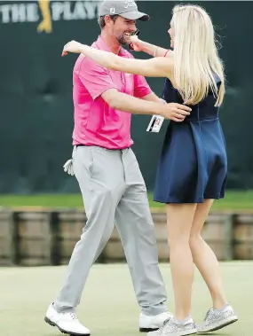  ?? THE ASSOCIATED PRESS JOHN RAOUOX/ ?? Webb Simpson is greeted by wife Taylor Dowd Simpson after winning The Players Championsh­ip on Sunday. The victory moved Simpson to No. 20 in the world rankings.