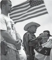  ?? AP ?? Rancher Cliven Bundy, flanked by armed supporters, speaks at a protest camp near Bunkervill­e, Nev., on April 18, 2014.