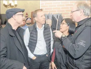  ?? MITCH MACDONALD/THE GUARDIAN ?? Don Jardine, right, project manager with UPEI’s Climate Research Lab, chats with senior research assistant Stephanie Arnold, Steve Arnold and Chris Buote, left, following a presentati­on at the Eagle Nest in North Rustico on Tuesday. Lab director Adam...