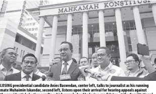  ?? AP/ACHMAD IBRAHIM ?? LOSING presidenti­al candidate Anies Baswedan, center left, talks to journalist as his running mate Muhaimin Iskandar, second left, listens upon their arrival for hearing appeals against the presidenti­al election results, which were lodged by losing candidates, at the Constituti­onal Court in Jakarta, Indonesia on Wednesday, March 27, 2024.