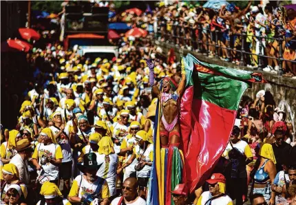  ?? Buda Mendes/Getty Images ?? Revelers attend the Carmelitas street party Friday on the first day of Carnival in Rio de Janeiro. The revelry comes after a dengue fever scare and drug-related violence in Brazil.