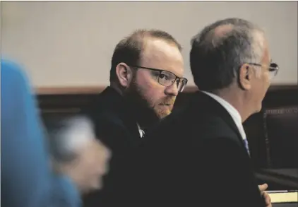  ?? AP PHOTO/STEPHEN B. MORTON ?? Travis McMichael (center) listens to his attorney Bob Rubin (right) during his trial in the Glynn County Courthouse, on Tuesday in Brunswick, Ga.