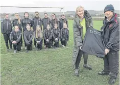  ?? ?? Beyond Housing’s Stephanie Lake hands the new kit to U14s boss Col Hepples