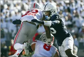  ?? BARRY REEGER — THE ASSOCIATED PRESS ?? Penn State safety Ji’Ayir Brown tackles Ohio State running back TreVeyon Henderson last month at Beaver Stadium. Brown leads the Nittany Lions with 55tackles and three intercepti­ons.