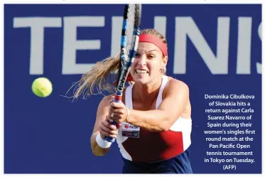  ??  ?? Dominika Cibulkova of Slovakia hits a return against Carla Suarez Navarro of Spain during their women's singles first round match at the Pan Pacific Open tennis tournament in Tokyo on Tuesday. (AFP)