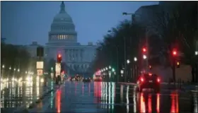  ?? J. SCOTT APPLEWHITE — THE ASSOCIATED PRESS FILE ?? In this file photo, The U.S. Capitol is seen in the distance as rain falls on Pennsylvan­ia Avenue in Washington. Why are Republican­s struggling mightily to reach a consensus on how to overhaul the nation’s tax system? The GOP is supposed to be really...