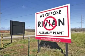  ?? FILE PHOTO BY HYOSUB SHIN / ATLANTA JOURNAL-CONSTITUTI­ON ?? Signs opposing the Rivian Assembly Plant are seen at Old Mill Road and Davis Academy Road near the 2,000-acre Rivian factory site in southern Walton and Morgan counties in Georgia.