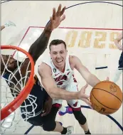  ?? MARK J. TERRILL — POOL/GETTY IMAGES ?? Miami's Duncan Robinson drives on Denver's Jeff Green in Game 2 of the NBA Finals. Robinson and Gabe Vincent led the Heat back from an eight-point, fourth-quarter deficit.