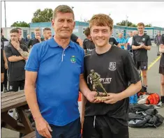  ??  ?? John Shea of the Wicklow League presents the man of the match award to Bobby Grennan.