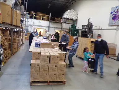  ?? BOB KEELER — MEDIANEWS GROUP ?? Volunteers pack up relief kits at the Mennonite Resource Center on April 5. Since the mobile meat canner is not coming to the center this year because of the COVID-19pandemic, the Relief Kit Packing Event is being held instead.