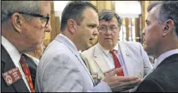  ?? BOB ANDRES / BANDRES@AJC.COM ?? Rep. Christian Coomer (second from left), R-Cartersvil­le, confers with colleagues, including Rep. Tom Taylor (left), R-Dunwoody, Rep. Rick Jasperse, R-Jasper, and Rep. Mark Newton, R-Augusta, over HB 452.