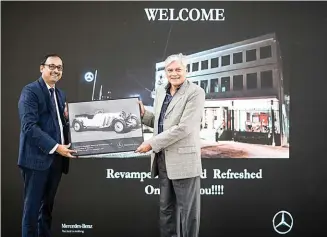  ??  ?? Managing director, Bridgeway Motors Ajmal Abdul Wahab recieves a photograph of a vintage Merc