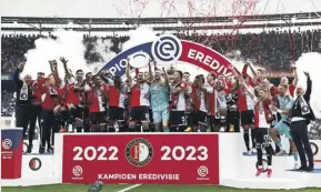  ?? ANP/GETTY IMAGES ?? ▲ Feyenoord players and staff celebrate winning the Eredivisie title in 2023