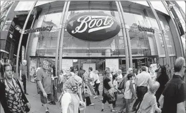  ?? Oli Scarff Getty Images ?? WALGREENS BOOTS is the largest retail pharmacy in the United States and Europe. It operates Boots stores in Europe and Asia and Walgreens and Duane Reade stores in the U.S. Above, a Boots store in London.
