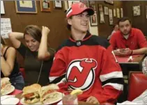  ?? SETH WENIG, THE ASSOCIATED PRESS ?? New Jersey Devils’ Nico Hischier talks with patrons at Hobby’s Deli in Newark, N.J., on Monday. He was the No. 1 pick in the NHL draft.