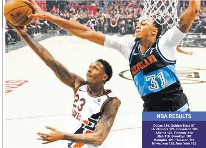  ?? (AP) ?? CLEVELAND’S John Henson (right) blocks LA Clippers’ Lou Williams during their NBA game Tuesday in LA which the Clippers won, 128-103.