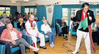  ??  ?? ● Pendine Park Bryn Seiont Newydd Caernarfon: A 50th birthday surprise for one of the younger residents, Ivan Chambers of Bangor, seated front row, centre. Picture: Rick Matthews