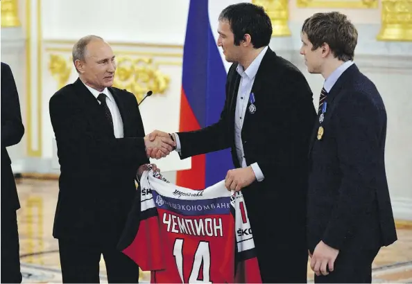  ?? YURI KADOBNOV/THE CANADIAN PRESS/FILES ?? Vladimir Putin, left, can count on the support of many of Russia’s top sports stars, including NHL forward Alex Ovechkin, centre, in this weekend’s presidenti­al election.