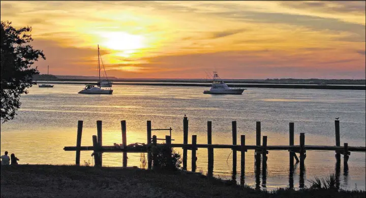  ?? MARJIE LAMBERT / MIAMI HERALD ?? Sunset casts a pretty picture at the Fernandina Harbor Marina on Amelia Island, Fla.