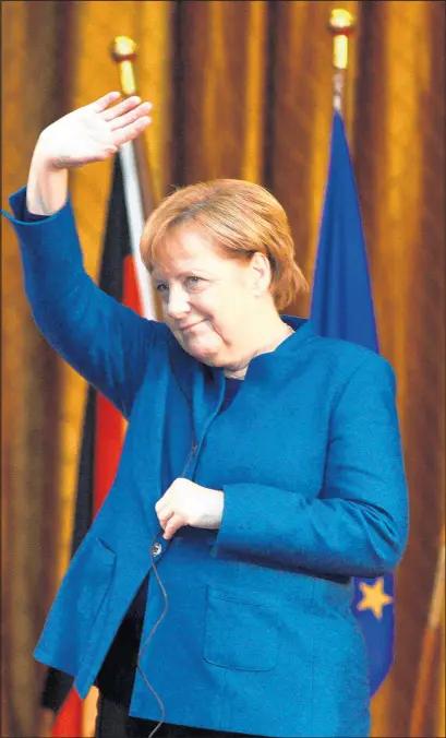  ?? SERGEI CHUZAVKOV/GETTY ?? German Chancellor Angela Merkel waves during meeting Thursday with students of Shevchenko University in Kiev. Merkel announced this week that she will not seek re-election in 2021.