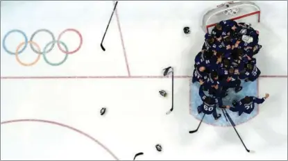  ?? BRIAN SNYDER / REUTERS ?? Finland players celebrate after beating the Russian Olympic Committee in the Beijing 2022 men’s ice hockey final on Feb 20, in the last medal event of the Games.