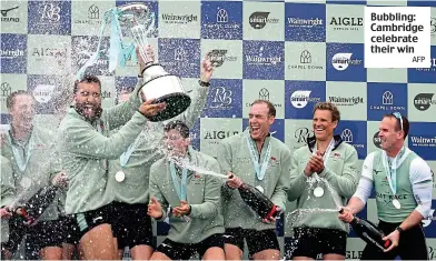  ?? AFP ?? Bubbling: Cambridge celebrate their win